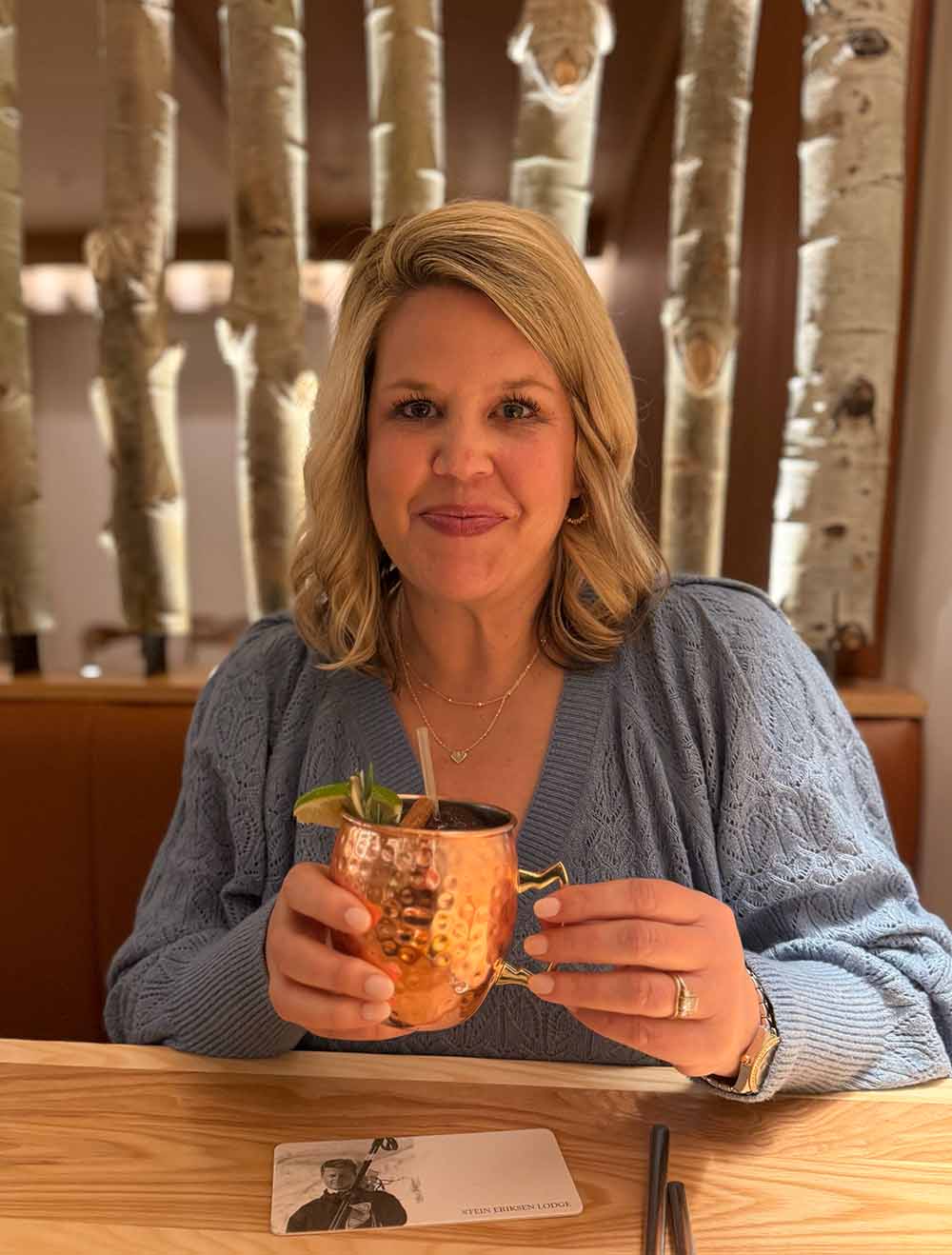 Woman with cocktail at Chateaux Deer Valley