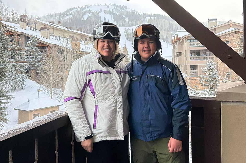 Mother and son in ski clothes on balcony
