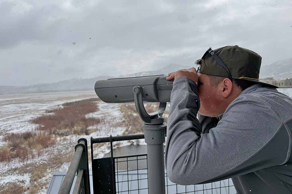 Teenager looking out of telescope
